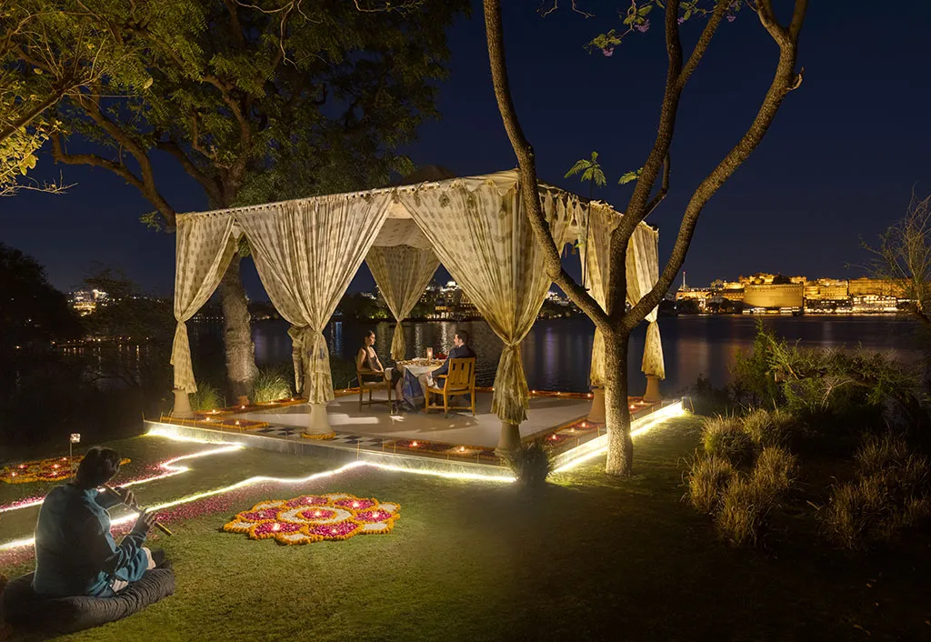 Couple enjoying a romantic luxury dinner in a historic Indian royal heritage setting