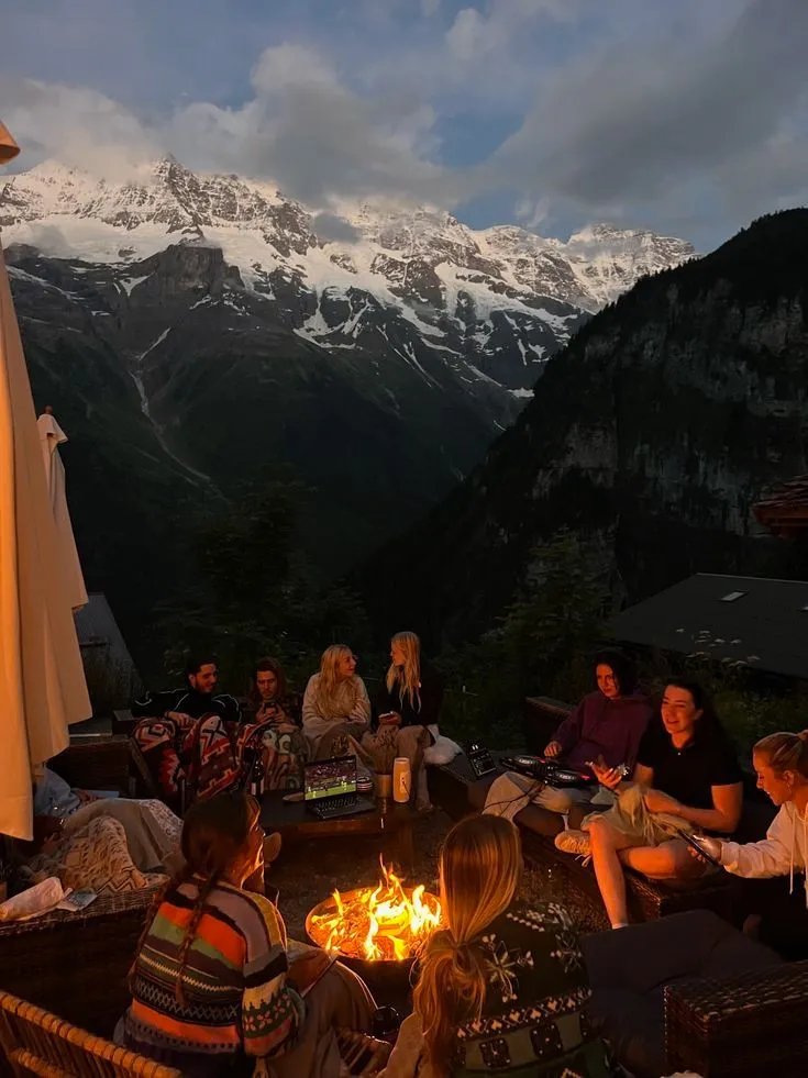 Group of travelers enjoying a cozy bonfire surrounded by the mountains of India