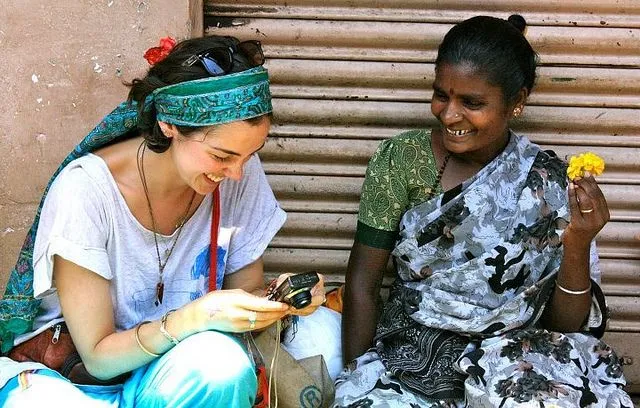 International travelers sharing a warm cultural experience with local people in India
