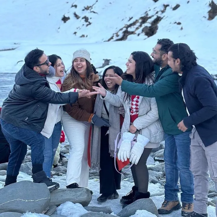 Family enjoying a fun luxury winter holiday in the snow-covered mountains of India